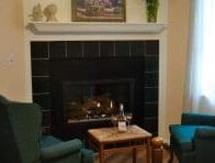 two blue chairs in front of fireplace